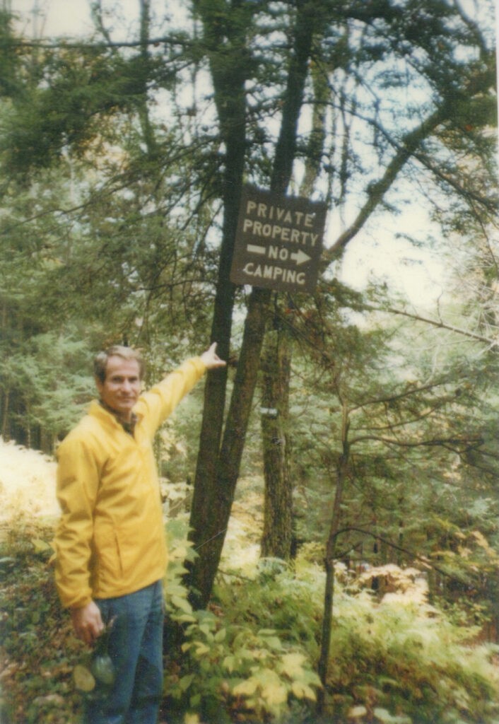 Klaus Hallig Pointing to the “No Trespassing” Sign at the Club Grounds