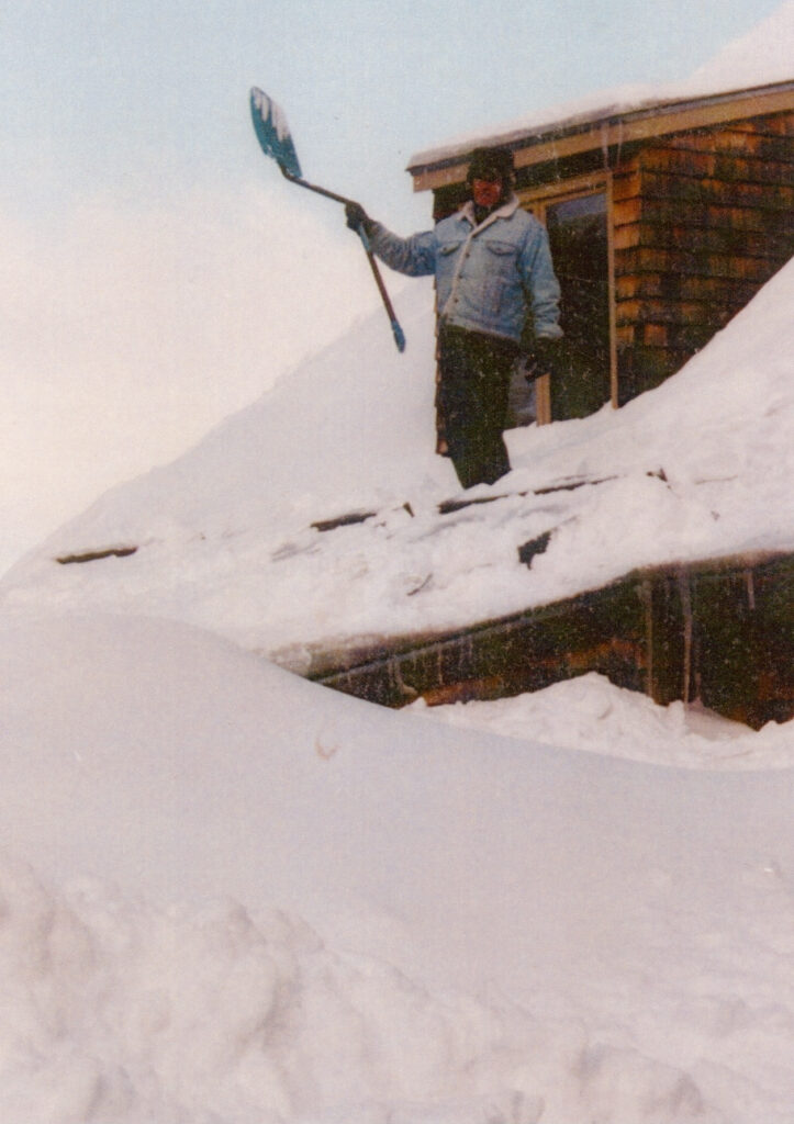 Klaus Hallig Shoveling Snow Off the Roof of Bobbie’s and His House at the Club Grounds